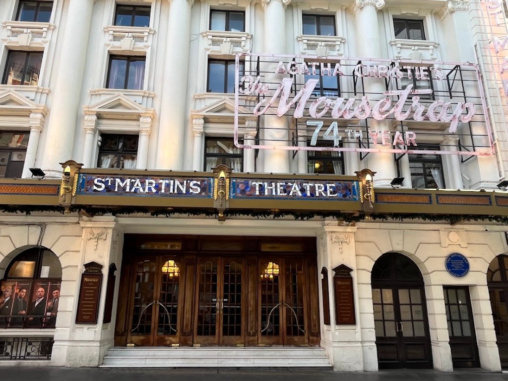 exterior shot of St Martin's Theatre when neon sign for The Mousetrap can be seen